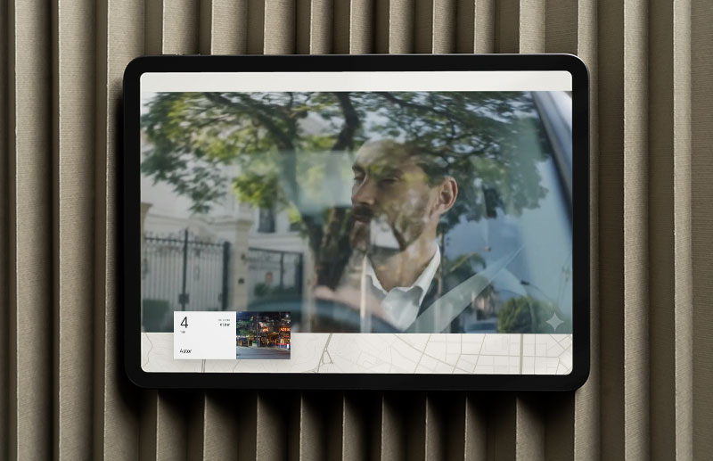 Website screen featuring a video of a man seen through the window of a moving car, with trees and urban architecture reflected on the glass. Small graphic modules at the bottom introduce content related to the location and surroundings of Blend 468.