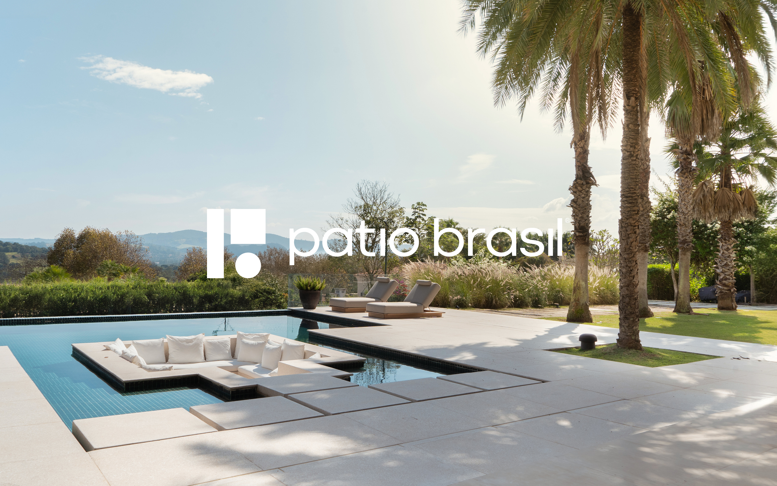 White Patio Brasil logo applied over a photograph of a contemporary residence with a swimming pool, landscaping and outdoor furniture. The image presents the visual identity integrated with the brand’s architecture, nature and outdoor living universe.